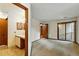 Spacious bedroom with carpet, ensuite vanity and sliding glass doors to a private balcony at 2960 Shadow Creek Dr # 201, Boulder, CO 80303