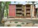 Multi-story condo building with red and yellow siding, featuring private balconies and landscaped grounds at 2960 Shadow Creek Dr # 201, Boulder, CO 80303