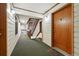 Hallway showing door and stairwell with white walls and green carpet at 2960 Shadow Creek Dr # 201, Boulder, CO 80303