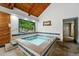 Indoor hot tub with steps up and a wood paneled ceiling at 2960 Shadow Creek Dr # 201, Boulder, CO 80303