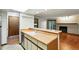 Open kitchen view with a breakfast bar, wood countertops, and a glimpse of the living room with fireplace at 2960 Shadow Creek Dr # 201, Boulder, CO 80303