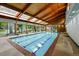 Indoor community pool with wood paneling and skylights over three-lane pool at 2960 Shadow Creek Dr # 201, Boulder, CO 80303