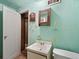 Small bathroom with single sink vanity and tiled floors and green walls at 1450 Joliet St, Aurora, CO 80010