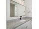 Modern bathroom featuring granite countertop and a sleek, rectangular mirror at 6429 Stable View St, Castle Pines, CO 80108