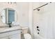 Modern bathroom featuring a granite countertop, framed mirror, and shower-tub combo with stylish fixtures at 6429 Stable View St, Castle Pines, CO 80108