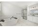 Luxurious bathroom featuring a soaking tub, walk-in shower, and a modern vanity with elegant fixtures at 6429 Stable View St, Castle Pines, CO 80108