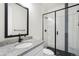 Modern bathroom with a glass-enclosed shower and granite countertop at 6429 Stable View St, Castle Pines, CO 80108