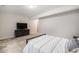 Cozy bedroom setup with dresser and large television, perfect for relaxation and comfort at 6429 Stable View St, Castle Pines, CO 80108