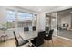Dining room with large windows, a modern table, and access to an outdoor patio at 6429 Stable View St, Castle Pines, CO 80108
