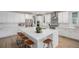 Bright kitchen featuring white cabinets, stainless steel appliances, and a large island with seating at 6429 Stable View St, Castle Pines, CO 80108