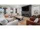 Contemporary living room with fireplace, plush seating, and stylish decor at 6429 Stable View St, Castle Pines, CO 80108