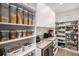 Walk-in pantry with ample shelving and storage, ideal for organized food storage at 6429 Stable View St, Castle Pines, CO 80108