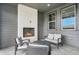 Covered patio with brick fireplace and outdoor seating, ideal for entertaining at 6429 Stable View St, Castle Pines, CO 80108