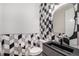 Stylish powder room with geometric tile, a modern sink, and sleek fixtures at 6429 Stable View St, Castle Pines, CO 80108