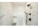 Modern shower showcasing marble tile, dual showerheads, a built-in bench, and sleek black fixtures at 6429 Stable View St, Castle Pines, CO 80108