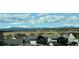 Scenic view of the neighborhood with mountains in the background under a partly cloudy blue sky at 6429 Stable View St, Castle Pines, CO 80108