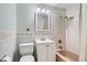 Classic bathroom with a tub and shower combo, accented with decorative tile and bright lighting at 8075 Sunset Dr, Lakewood, CO 80214