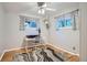 Bright bedroom with hardwood floors, white walls, and a stylish desk area at 8075 Sunset Dr, Lakewood, CO 80214