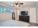 Comfortable bedroom with a large dresser and flat screen, offering great storage and entertainment options at 8075 Sunset Dr, Lakewood, CO 80214