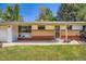 Close-up of the front of a single-story house with brick and a well-kept yard at 8075 Sunset Dr, Lakewood, CO 80214