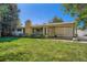Charming home with well-maintained lawn and covered patio, perfect for outdoor living at 8075 Sunset Dr, Lakewood, CO 80214