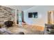 Open-concept living room with hardwood floors, brick fireplace, and plenty of light at 8075 Sunset Dr, Lakewood, CO 80214
