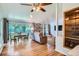 Inviting living room featuring wood floors, exposed brick wall and oversized windows offering a relaxing atmosphere at 8075 Sunset Dr, Lakewood, CO 80214
