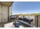 Staged outdoor balcony with a comfortable sofa, grill and a view of the surrounding area at 1313 S Clarkson St # 205, Denver, CO 80210