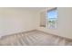 Bright bedroom featuring a large window providing natural light and neutral carpeting at 1313 S Clarkson St # 205, Denver, CO 80210