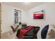 Well-lit bedroom with modern desk, neutral carpet, and large window at 1313 S Clarkson St # 205, Denver, CO 80210