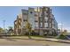 Inviting multi-story condo building with brick facade and manicured landscaping at 1313 S Clarkson St # 205, Denver, CO 80210