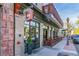 Brick exterior of a restaurant with large glass windows, outdoor seating, and street view in daylight at 1313 S Clarkson St # 205, Denver, CO 80210