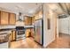 Well-equipped kitchen featuring stainless steel appliances, ample cabinetry, and hardwood floors at 1313 S Clarkson St # 205, Denver, CO 80210