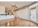 Open floor plan with hardwood floors, a door to a balcony, and a kitchen island at 1313 S Clarkson St # 205, Denver, CO 80210