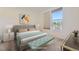 Bright main bedroom featuring neutral decor, a large window, and bench at 1313 S Clarkson St # 205, Denver, CO 80210