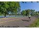 Scenic park view with a cyclist on the road, surrounded by trees and a serene lake backdrop at 1313 S Clarkson St # 205, Denver, CO 80210