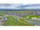 Aerial view of the community featuring well maintained homes, walking paths, and green space at 722 Eva Peak Dr, Erie, CO 80516