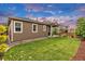 Spacious backyard with green grass, nice landscaping, and covered patio, great for entertaining at 722 Eva Peak Dr, Erie, CO 80516