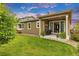 Exterior view of the house and backyard with a covered patio perfect for outdoor entertaining at 722 Eva Peak Dr, Erie, CO 80516