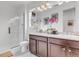 Clean bathroom with double vanity, walk-in shower, and modern fixtures at 722 Eva Peak Dr, Erie, CO 80516