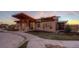 Exterior of the clubhouse, showcasing the modern design, stone accents and covered entry at 722 Eva Peak Dr, Erie, CO 80516