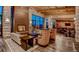 Community clubhouse with high ceilings, stone fireplace, modern chandeliers, and lounge seating at 722 Eva Peak Dr, Erie, CO 80516