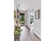 Bright entryway with wood flooring, a decorative table, and a view of the front yard and home interior at 722 Eva Peak Dr, Erie, CO 80516