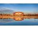 Beautiful lakefront property with stunning architecture reflected in the water at 722 Eva Peak Dr, Erie, CO 80516