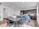 Well-lit kitchen with a large island, modern appliances, and an open layout leading to the dining area at 722 Eva Peak Dr, Erie, CO 80516