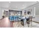Bright and modern kitchen with a central island, stainless steel appliances, and an adjacent dining area at 722 Eva Peak Dr, Erie, CO 80516