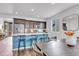 Modern kitchen features stainless steel appliances, dark wood cabinets, breakfast bar, and adjacent dining area at 722 Eva Peak Dr, Erie, CO 80516