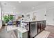 Spacious kitchen with a large island, stainless steel appliances, and an open view to the Gathering room at 722 Eva Peak Dr, Erie, CO 80516