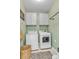 Functional laundry room with modern washer, dryer, and wall mounted cabinets for storage at 722 Eva Peak Dr, Erie, CO 80516