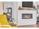 Cozy living room with a fireplace, floating wood mantle, and a view into the main bedroom at 722 Eva Peak Dr, Erie, CO 80516